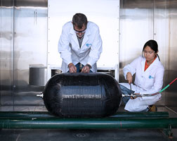 Image of two people conducting gas cycle chamber tests.