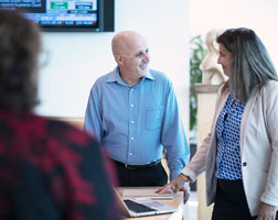 Image of a group of people in an office setting having a discussion.